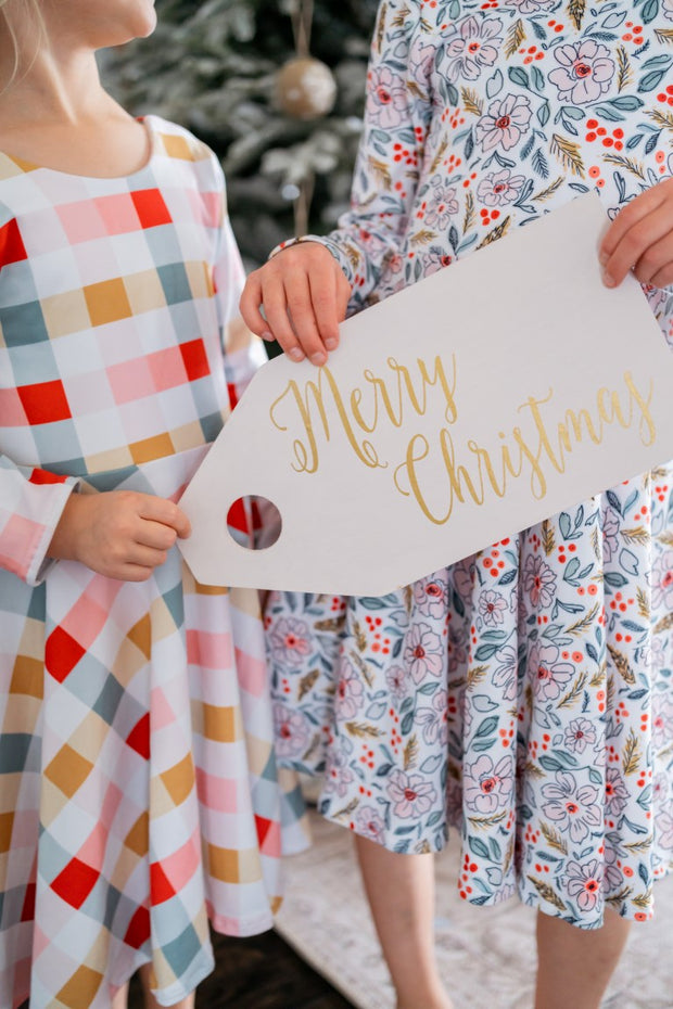 Girls coordinating Christmas twirl dresses in a bright watercolor floral and gingham
